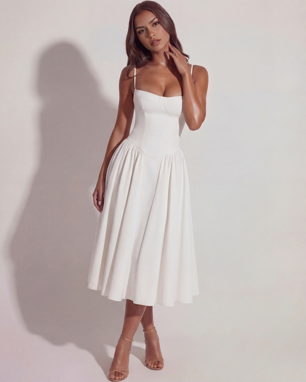White midi dress with spaghetti straps, fitted waist, and pleated A-line skirt, 3/4 view.
