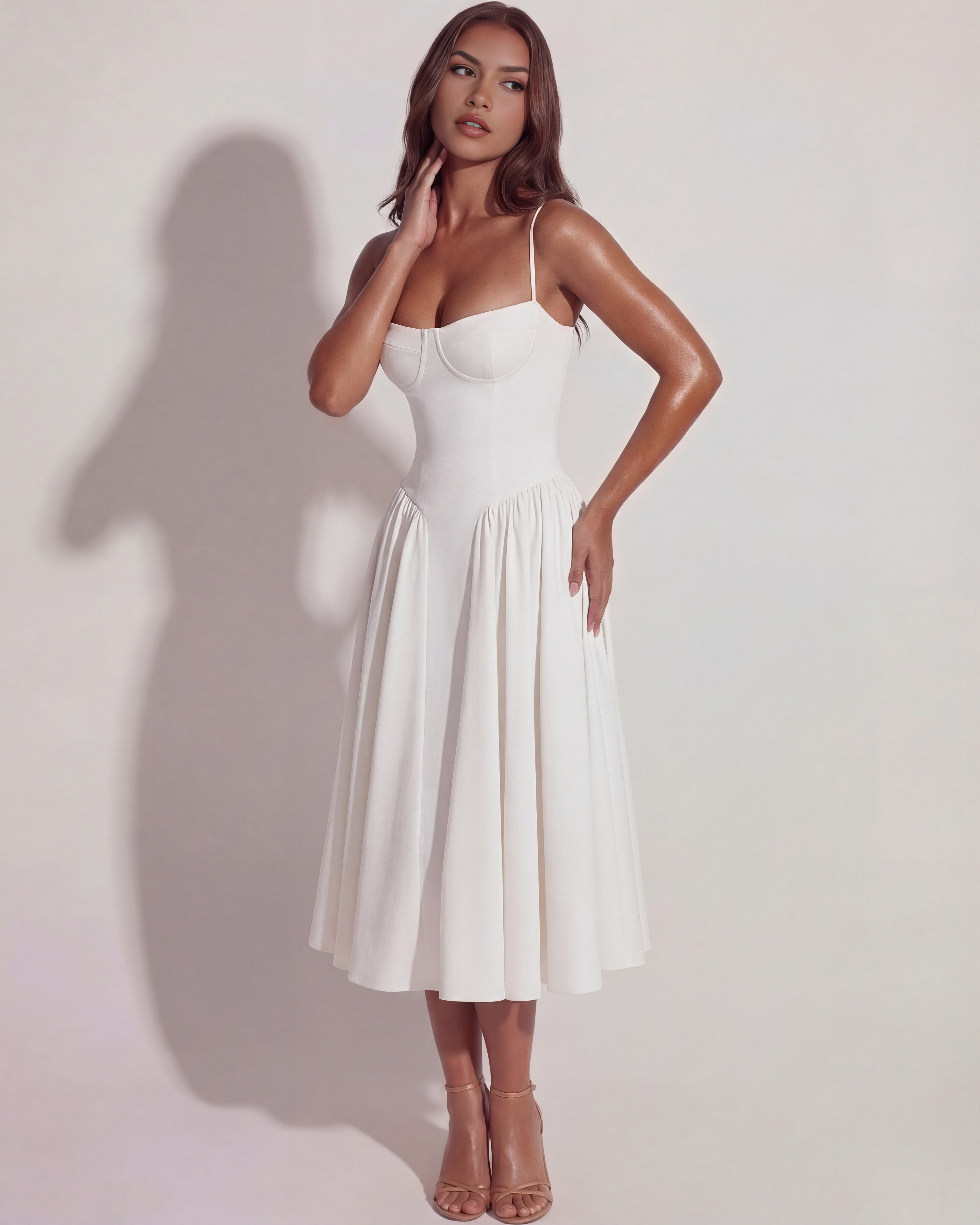 White midi dress with spaghetti straps, fitted bodice, and gathered skirt, 3/4 view.