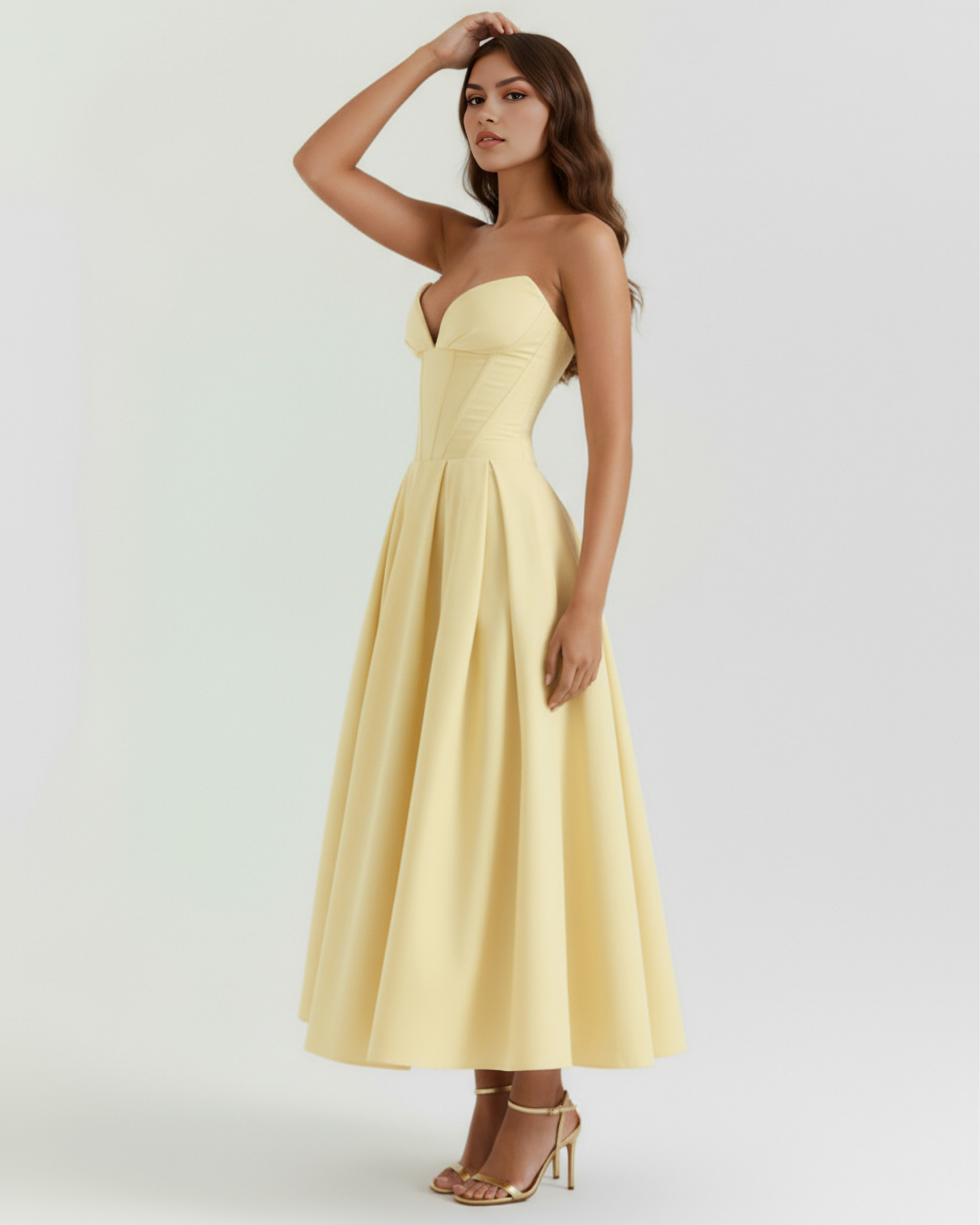 Light yellow strapless sweetheart corset midi dress in profile with pleated skirt